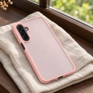 DUXDUCIS Phone Case for Samsung A17 5G-A26 5G-A16 4G-A16 5G - Light Pink Samsung A17 / A26 / A16 case on ivory linen on a dark walnut windowsill beside an amber vase