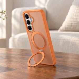 DUXDUCIS Phone Case for Samsung S26 Plus With Stand - Orange Samsung S26 Plus case supported in portrait orientation on a walnut coffee table beside a blue-glass vase and cream linen sofa