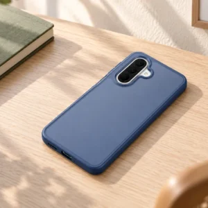 DUXDUCIS Phone Case for Samsung A27 - Dark Blue Samsung A27 case on a pale ash-wood writing table beside an olive-green notebook and mustard-yellow pencil cup