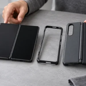 Unbranded foldable phone cases and sample components arranged for a buyer review