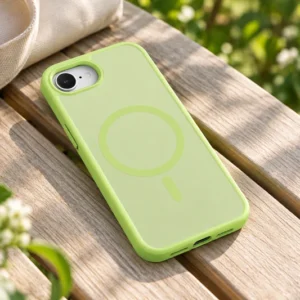 DUXDUCIS Phone Case for iPhone-16e - Lime Green case on a sunlit timber garden bench beside a canvas tote