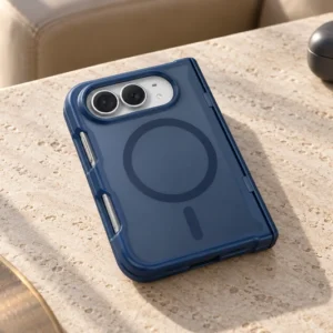 DUXDUCIS iPhone Duo with Magnetic - Dark Blue hinge-protection case on a travertine lounge table beside travel accessories